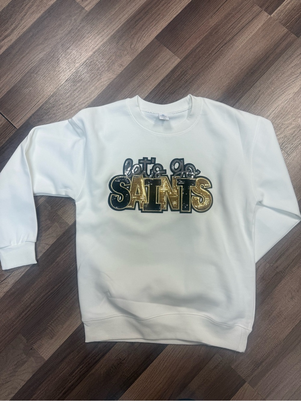 White Sweatshirt with Gold 'Saints' Graphic